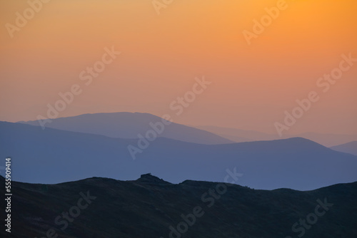 Wallpaper Mural mountain chain silhouette in blue mist at the sunset, early morning mountain travel scene Torontodigital.ca
