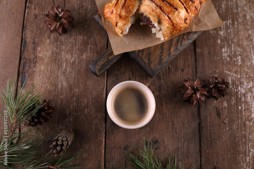 Fototapeta premium Croissant with chocolate on a wooden board on a wooden board