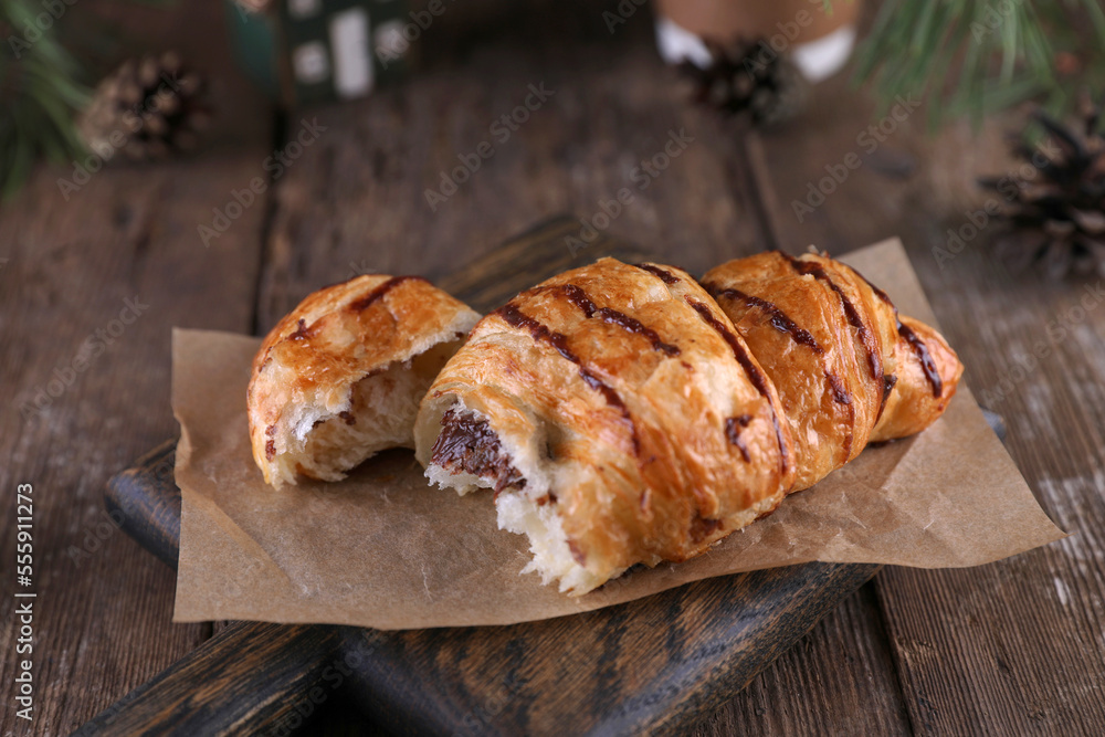 Croissant with chocolate on a wooden board on a wooden board Croissant with chocolate on a wooden board on a wooden board