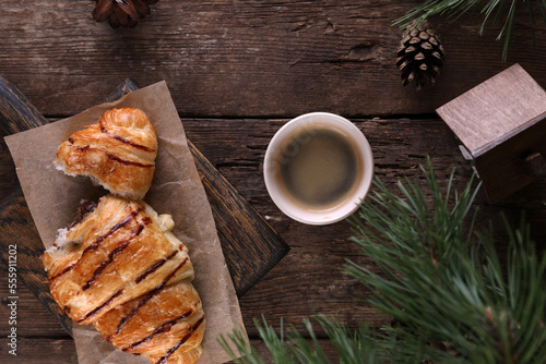 Croissant with chocolate on a wooden board on a wooden board