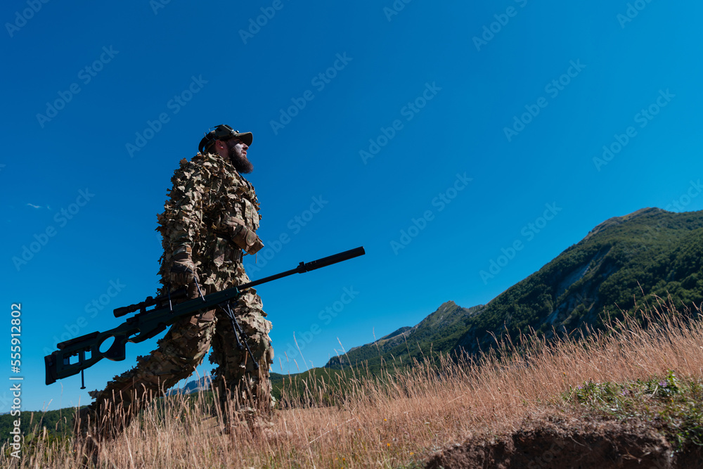 Army soldier holding a sniper rifle with scope and walking in the forest. war, army, technology and people concept. Army soldier holding a sniper rifle with scope and walking in the forest. war, army, technology and people concept.