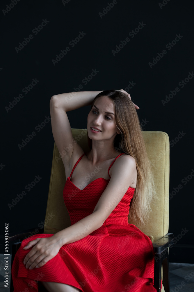 portrait of a young attractive woman on a dark background