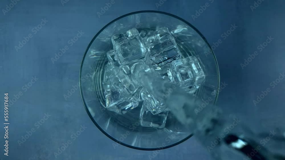 Slow Motion Detail Shot of Pouring water on Ice Cubes Slow Motion Detail Shot of Pouring water on Ice Cubes
