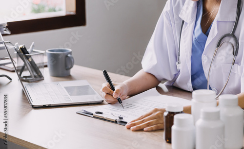 Homecare nursing service and elderly people cardiology healthcare. Close up of young hispanic female doctor nurse check mature caucasian man patient heartbeat using stethoscope during visit