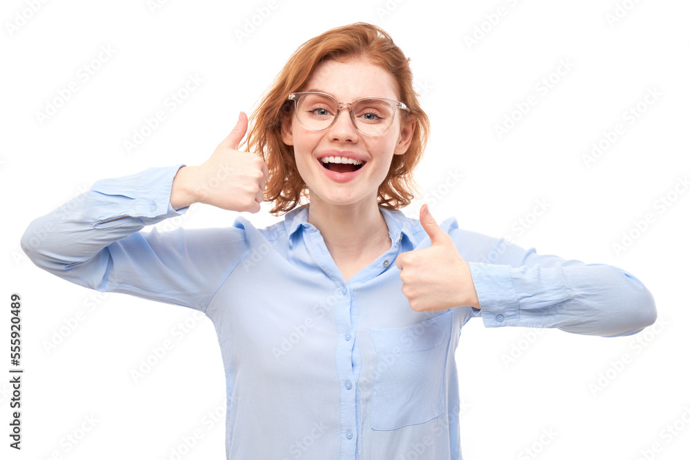 Young redhead woman shows hand with thumbs up and smiles at the camera isolated on white background