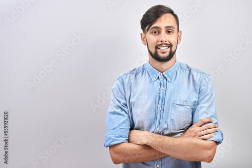 Portrait of young caucasian brunette bearded male positive smiling isolated on white studio background