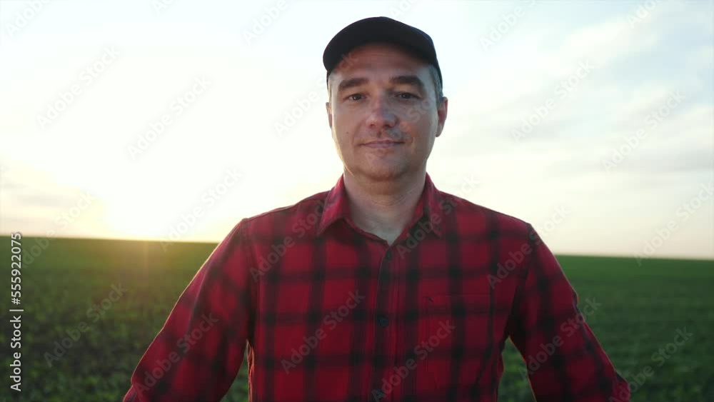 agriculture. farmer face portrait in field at harvest crop. agribusiness agriculture a harvesting concept. working farmer portrait stands in the field resting during the harvest agriculture. farmer face portrait in field at harvest crop. agribusiness agriculture a harvesting concept. working farmer portrait stands in the field resting during the harvest