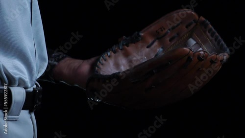 A baseball player pitcher with his baseball and baseball gloves