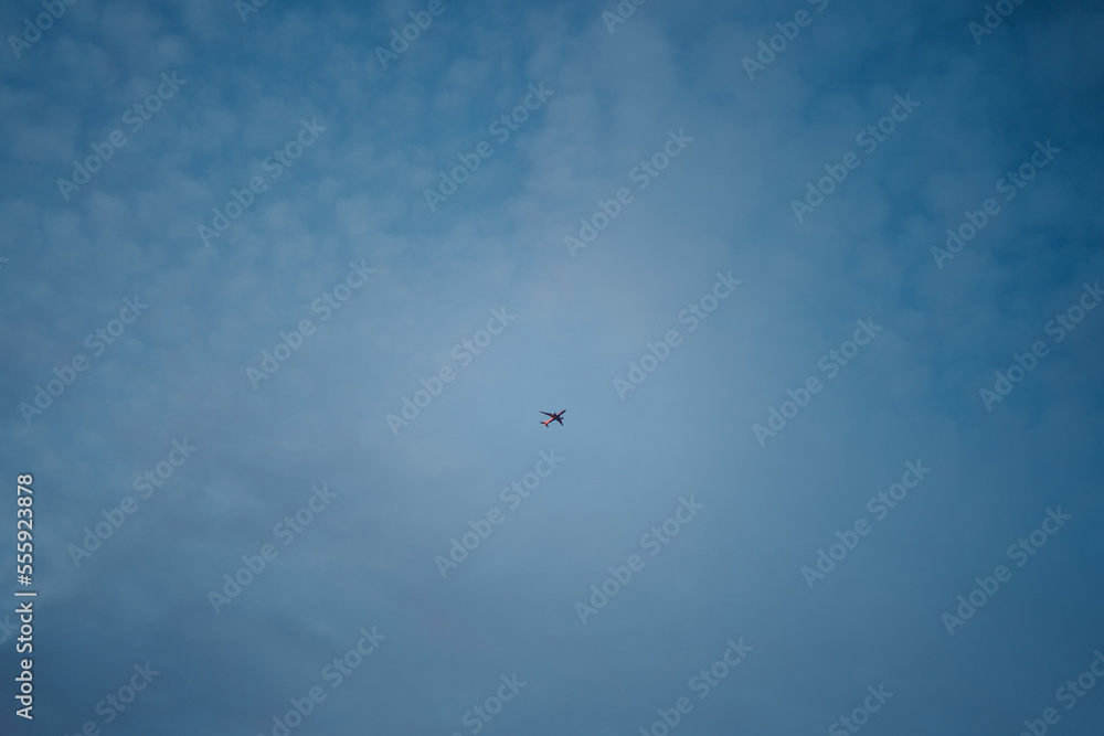 small minimalistic airplane flying high in the blue sky small minimalistic airplane flying high in the blue sky