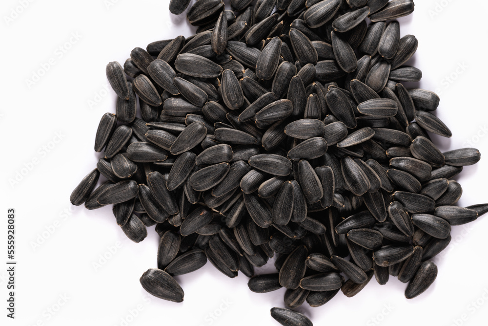 Heap of black sunflower seeds on a white background. Heap of black sunflower seeds on a white background.