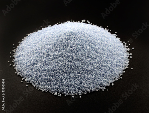 Palm wax for making candles on a black background. Blue Wax for bulk candles. A slide of palm wax granules close-up.