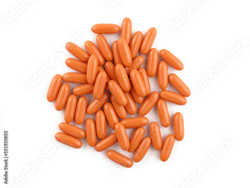 Oval orange capsules on a white background. Capsules in gelatin shell Q10 top view. Food supplement for brain activity. oval capsules with vitamins.