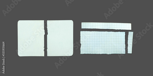 White ripped note, notebook paper stuck with sticky tape on black background.