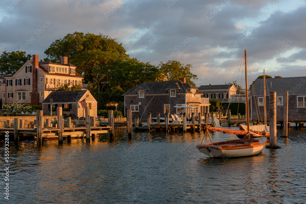 Golden hour sunrise along the Edgartown harborfront.  Sailboats, docks and homes are bathed in a quiet soft light.