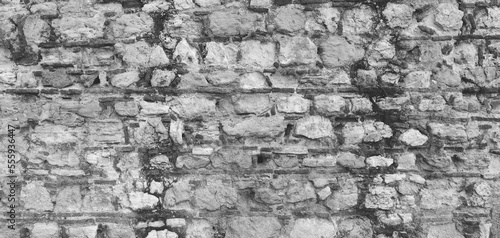 Empty Old Weathered Brick Wall Texture. Grungy Brickwork. Shabby Building Façade with Damaged Surface. Black and white