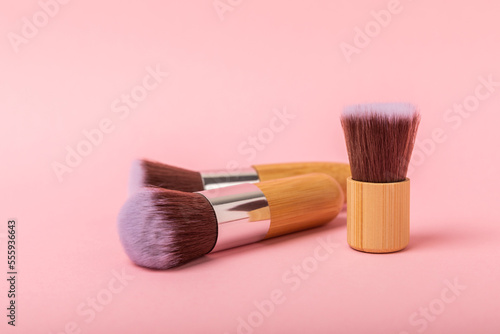 Makeup brushes on a pink background. Stylish background. Collection of cosmetic makeup brushes. Beautyconcept. Makeup tool. Place for text. Place to copy.