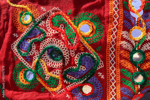 Red fabric with embroidery background with mirror work 