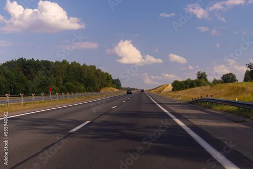 Highway wide road, transport and blue sky with clouds on a summer day