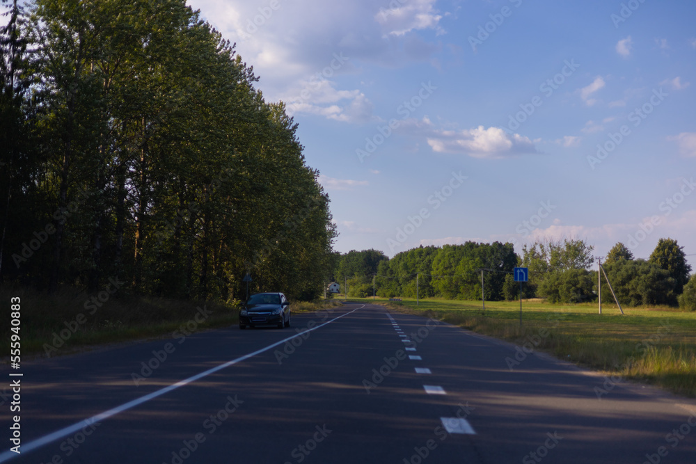 Highway wide road in the city, transport and blue sky with clouds on a summer day