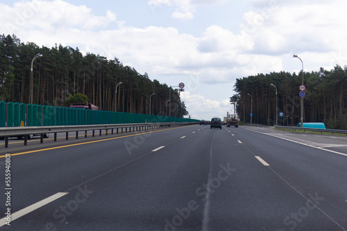 Highway wide road in the city  transport and blue sky with clouds on a summer day