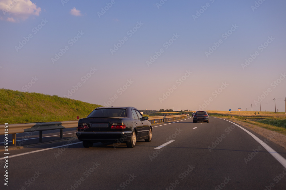 Evening view at sunset. Highway road in the countryside, roadside and asphalt