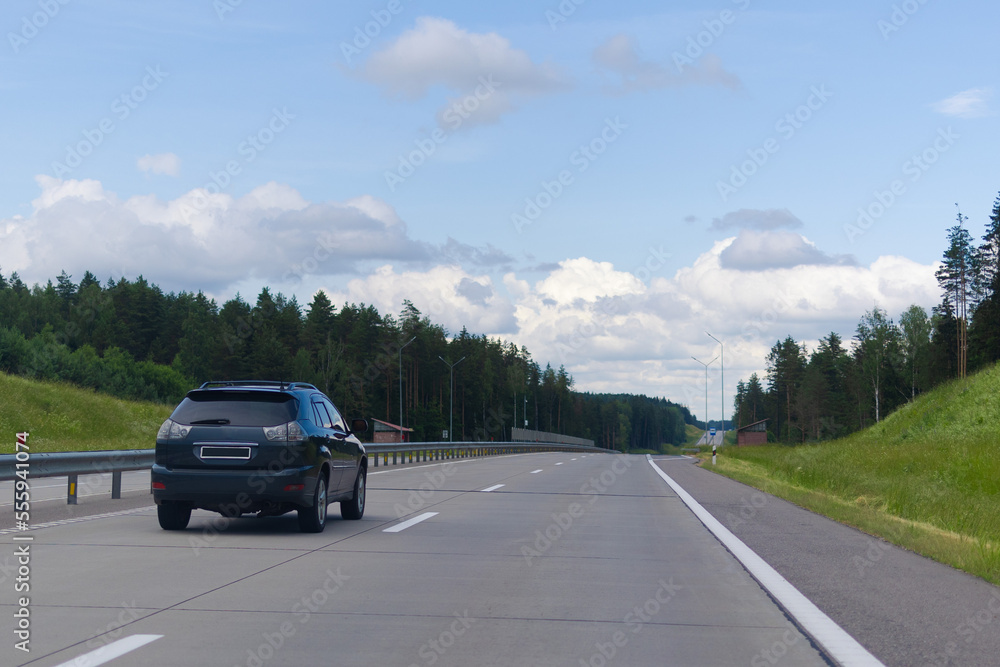 Highway wide road in the city, transport and blue sky with clouds on a summer day Highway wide road in the city, transport and blue sky with clouds on a summer day