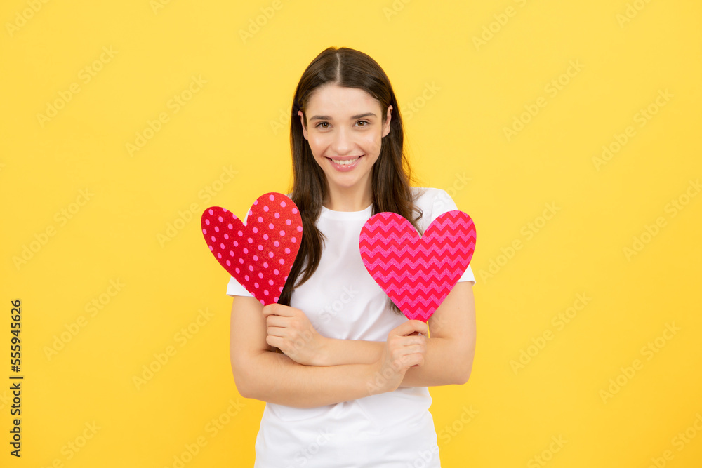 Beautiful amazing woman cuddle paper card heart shape, dreamy isolated on yellow background. Love concept. Beautiful amazing woman cuddle paper card heart shape, dreamy isolated on yellow background. Love concept.