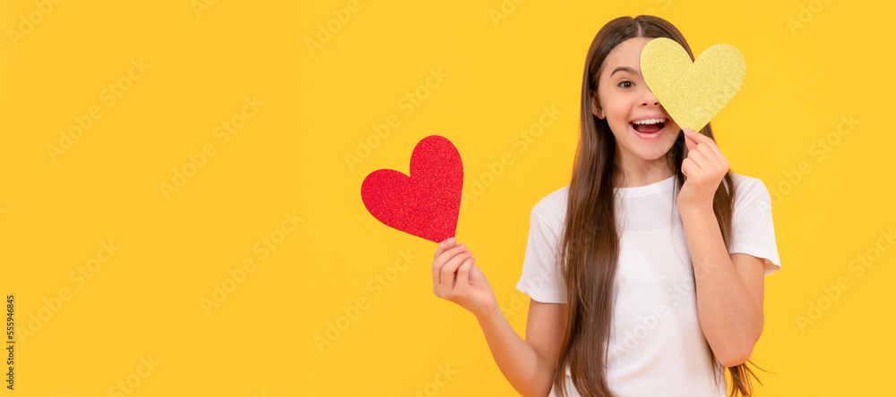 teen girl on yellow background. love present. surprised kid with love romantic gift. Kid girl portrait with heart love symbol, horizontal poster. Banner header with copy space. teen girl on yellow background. love present. surprised kid with love romantic gift. Kid girl portrait with heart love symbol, horizontal poster. Banner header with copy space.