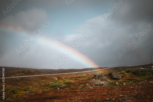 Landscape in northern Norway on a moody autumn day with a rainbow background