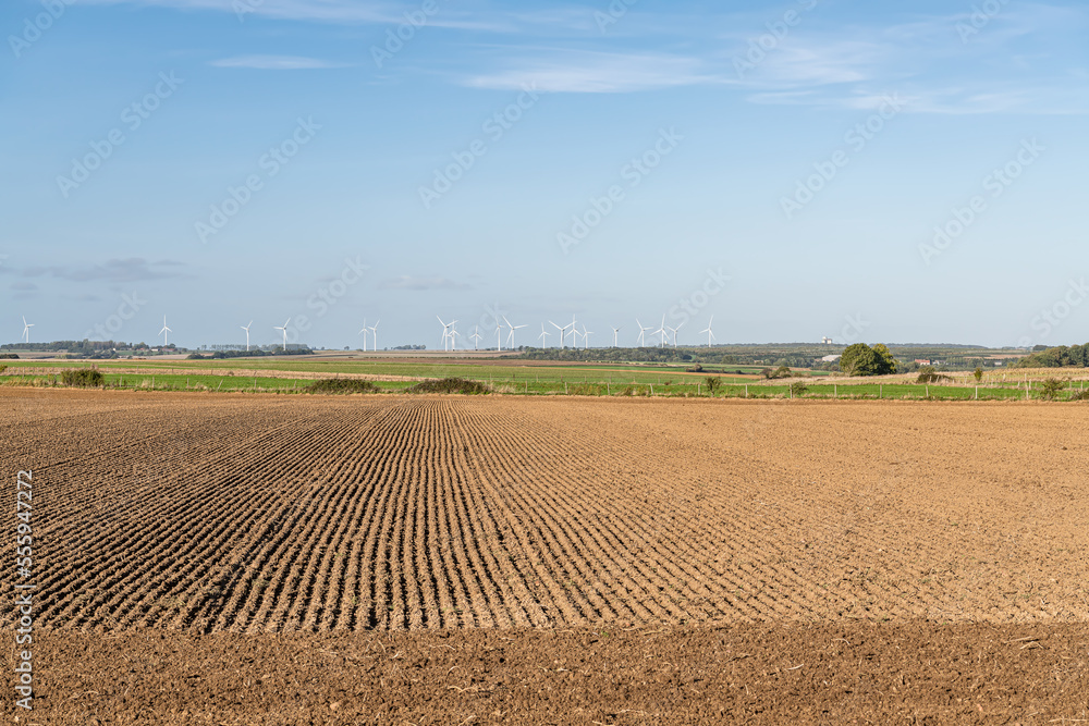 Flat farmland with distant wind turbines at Ligescourt in Northern France Flat farmland with distant wind turbines at Ligescourt in Northern France