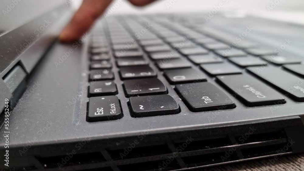 Man is cleaning his dirty laptop computer with his fingers. Care for computer equipment Man is cleaning his dirty laptop computer with his fingers. Care for computer equipment