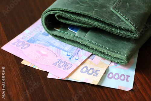 Ukrainian paper money in two hundred, five hundred and one thousand hryvnia bills. Green wallet.
