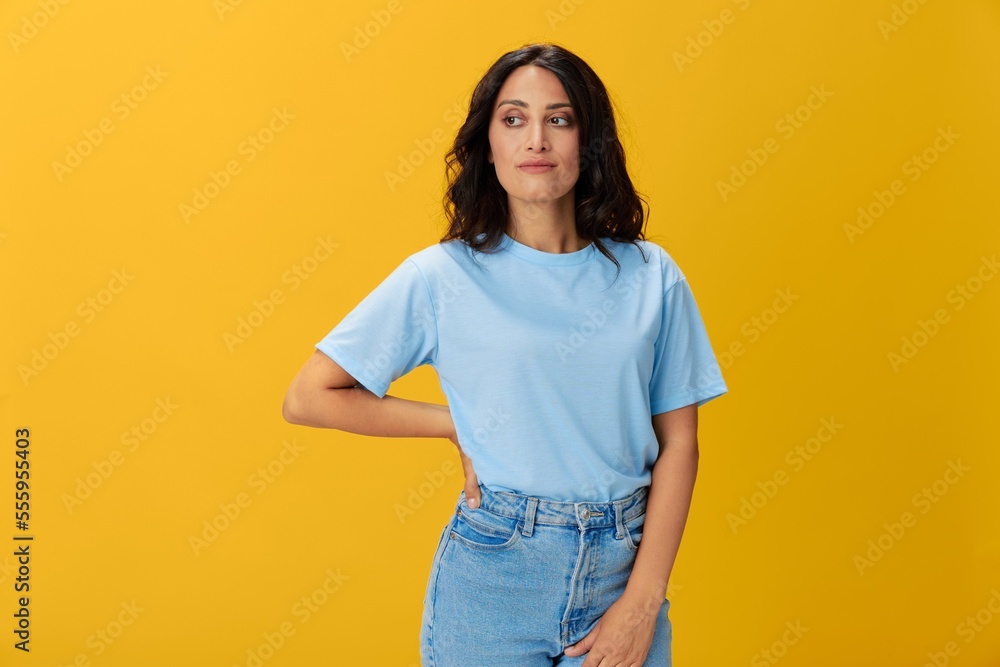 Woman signal smile with teeth emotion portrait in blue t-shirt on yellow background, hands up, surprise, lifestyle, copy space Woman signal smile with teeth emotion portrait in blue t-shirt on yellow background, hands up, surprise, lifestyle, copy space