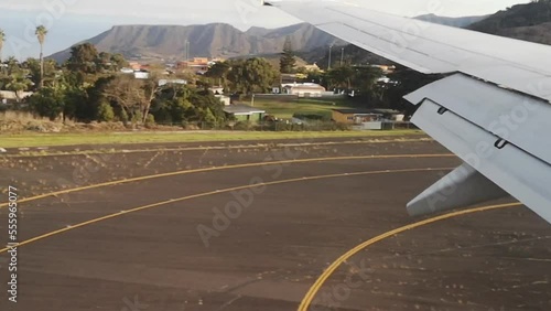 Tenerife, Spain - November 24, 2021: Ryanair plane landing at Tenerife Norte Airport in Canary Islands - view from the airplane window. Video 54 seconds. Airplane wing moves over volcanic landscapes
