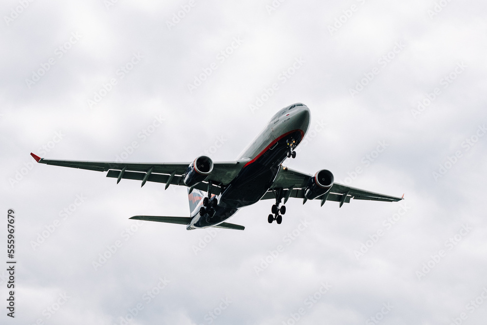 Passenger plane comes in for landing in cloudy weather. Passenger plane comes in for landing in cloudy weather.