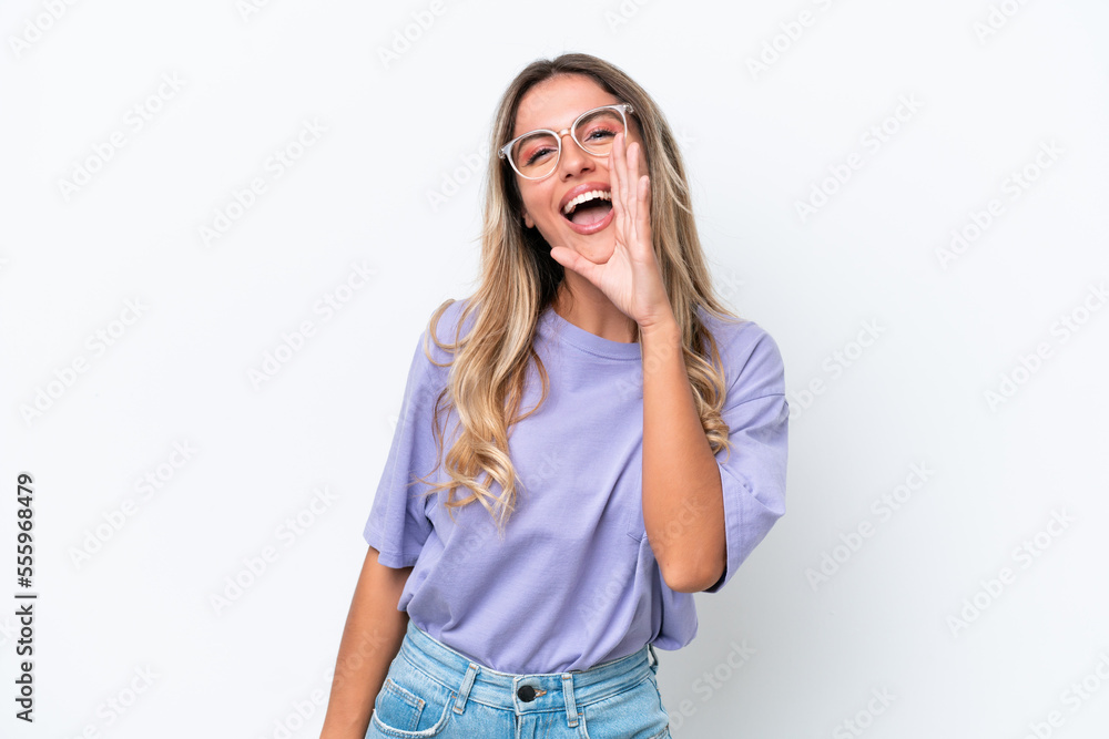 Young Uruguayan woman isolated on white background shouting with mouth wide open Young Uruguayan woman isolated on white background shouting with mouth wide open