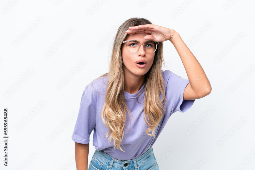 Young Uruguayan woman isolated on white background looking far away with hand to look something Young Uruguayan woman isolated on white background looking far away with hand to look something