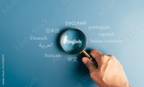 Fotografie Magnifier focus to english language translation or translate on worldwide language conversation speaking concept