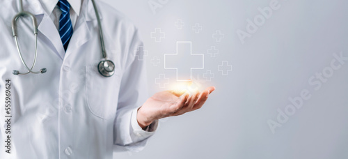 Doctor in white coat holding plus sign for positive healthcare insurance symbol concept, Mental health care, medical check up concept. photo