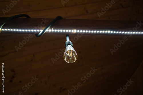 Fototapeta Naklejka Na Ścianę i Meble -  led light bulb in the industrial lamp is bright on the ceiling 