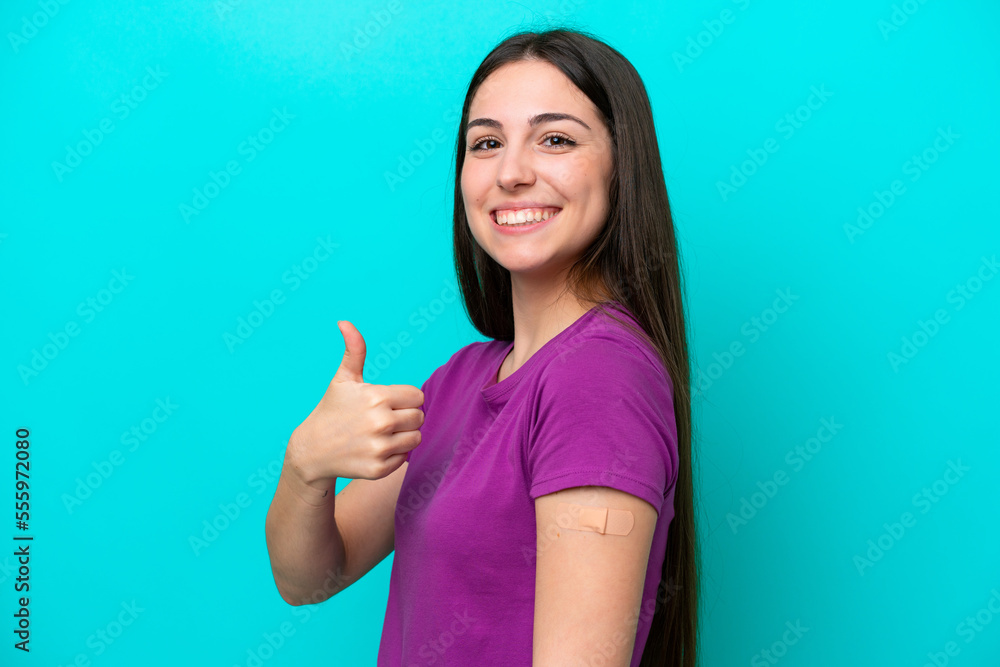 Young girl with band-aids isolated on blue background with thumbs up because something good has happened Young girl with band-aids isolated on blue background with thumbs up because something good has happened