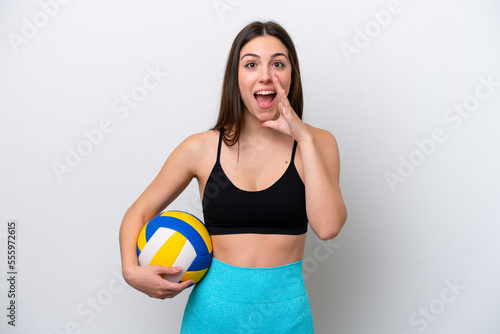 Young caucasian woman playing volleyball isolated on white background with surprise and shocked facial expression