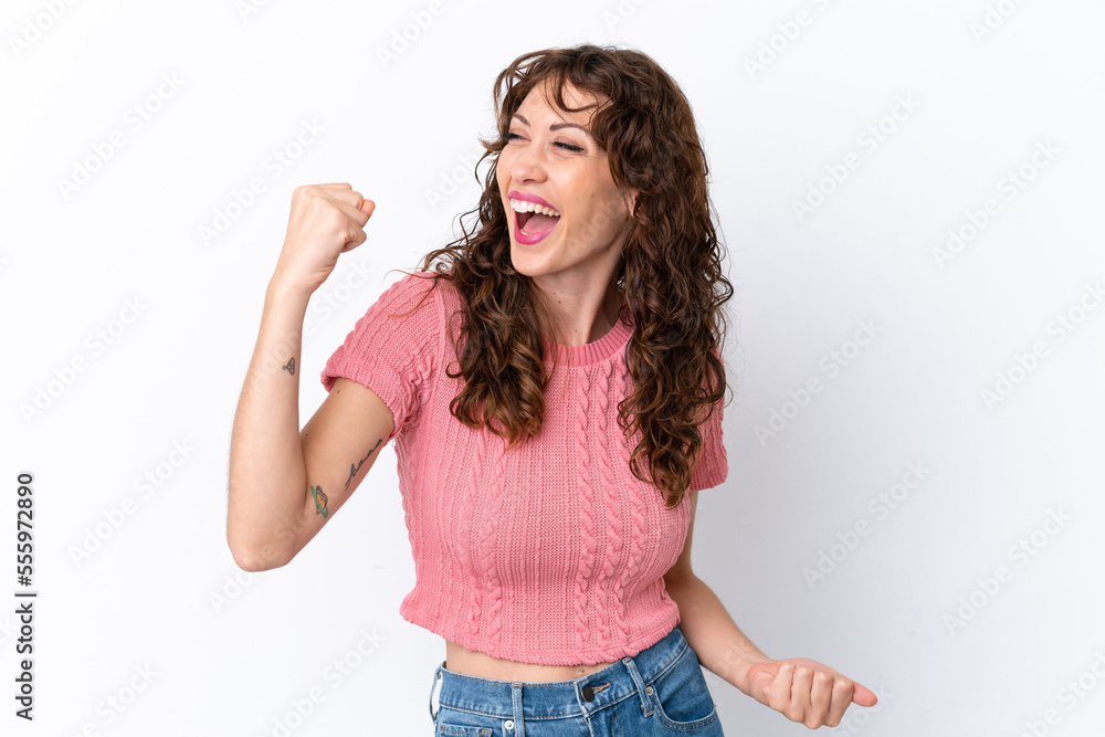 Young woman with curly hair isolated on white background celebrating a victory Young woman with curly hair isolated on white background celebrating a victory