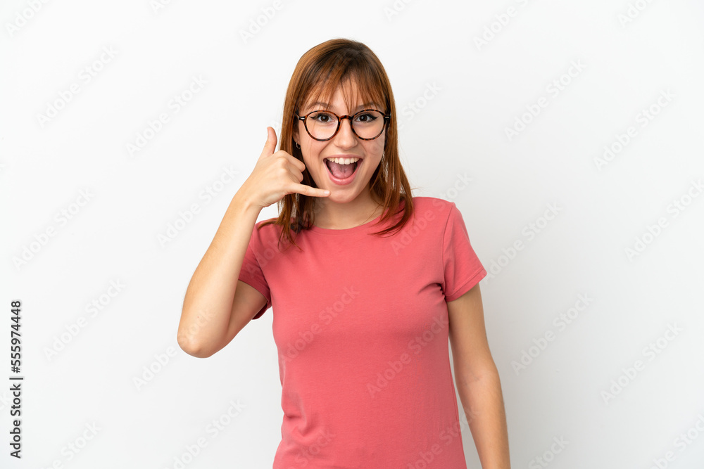 Redhead girl isolated on white background making phone gesture. Call me back sign