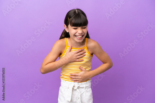 Little caucasian kid isolated on purple background smiling a lot