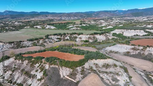 Erosion boulevards and riverside forest in the Veral river. Aerial view from a drone. Berdun. Municipality of the Canal de Berdún.The Jacetania. Huesca, Aragon, Spain, Europe photo