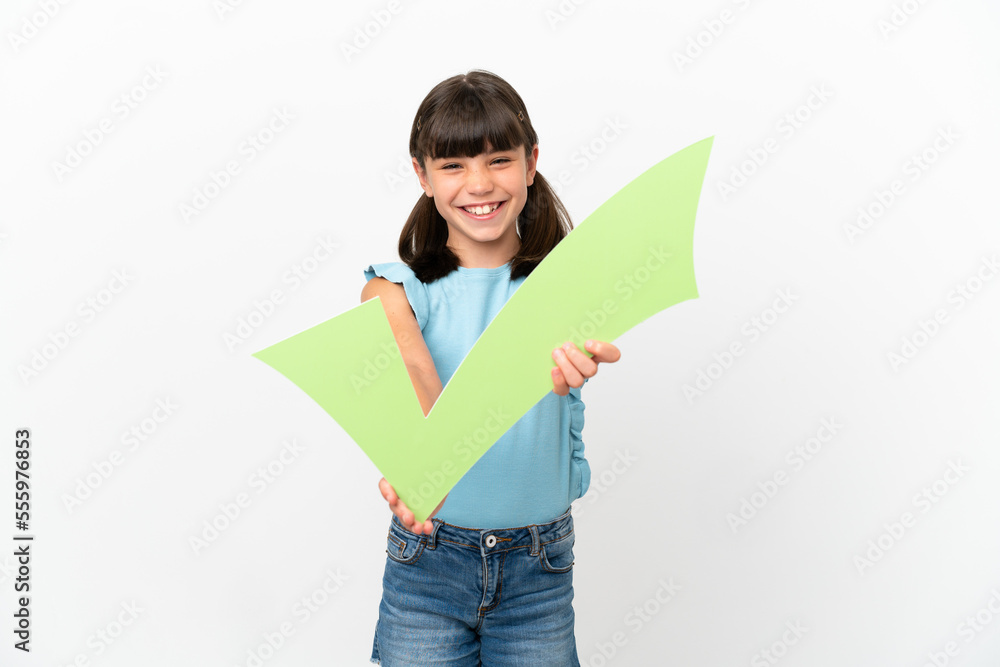 Little caucasian kid isolated on white background holding a check icon with happy expression Little caucasian kid isolated on white background holding a check icon with happy expression