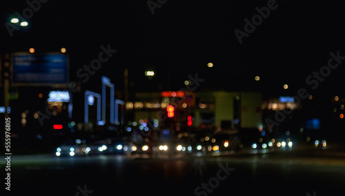 Colorful background of night street with defocused light cars and street lamps. Abstract backdrop of bokeh blurred lights at city life. Concept of cityscape backgrounds for design. Copy text space