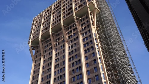 Footage and zoom of Velasca Tower, skyscraper built in the 1950s by the BBPR architectural partnership, seen from below, in Milan city center, Lombardy region, Italy photo