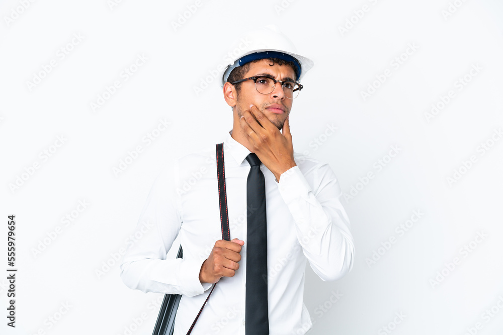 Architect brazilian man with helmet and holding blueprints having doubts Architect brazilian man with helmet and holding blueprints having doubts